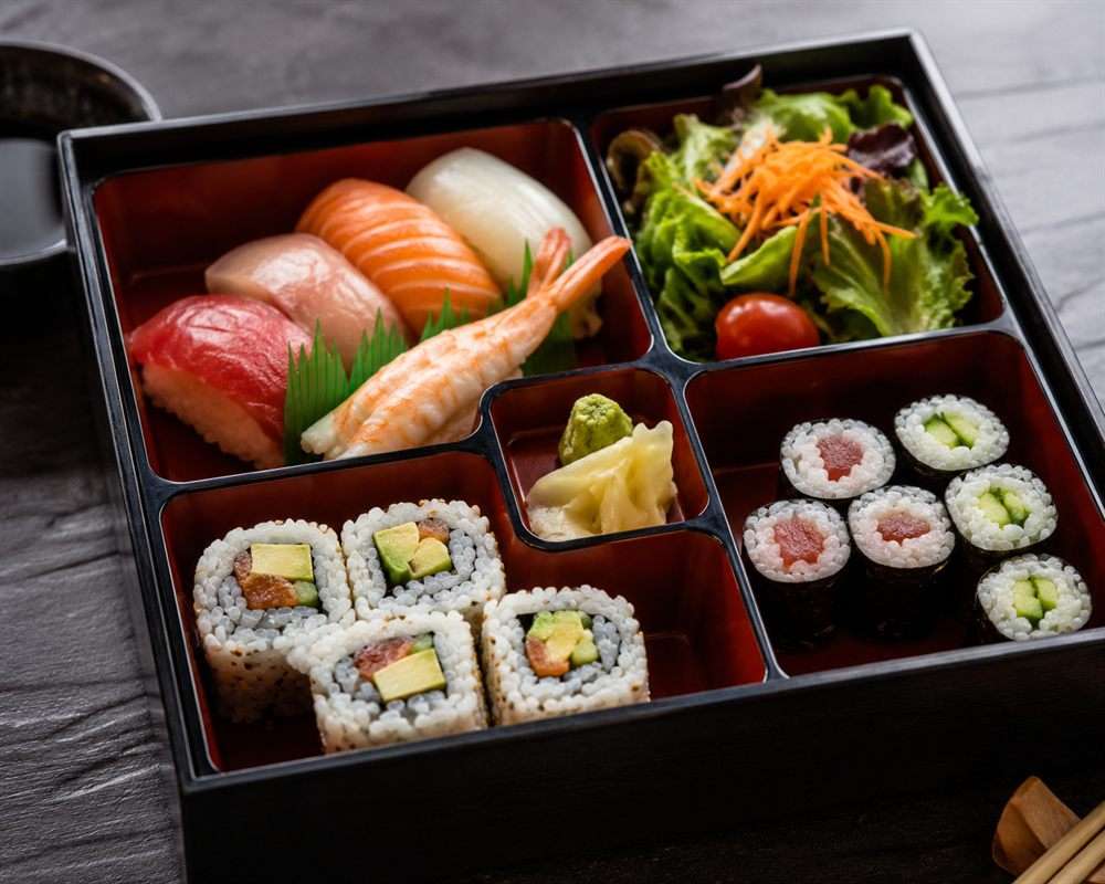 Luko snapping a photo of a sushi bento on a phone